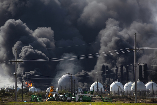 Ray Moore and Milton Perio observe the fire consuming TPC Group plant on Wednesday, Nov. 27, 2019, in Port Neches, Texas. Two massive explosions 13 hours apart tore through the chemical plant Wednesday, and one left several workers injured. [Photo: AP/Marie D. De Jesús/Houston Chronicle]