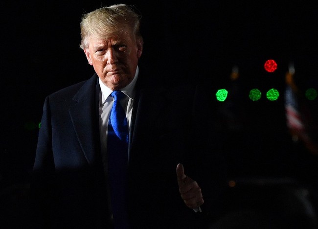 U.S. President Donald Trump gestures after disembarking from Air Force One after landing at Stansted Airport, northeast of London on December 2, 2019. [Photo: AFP]