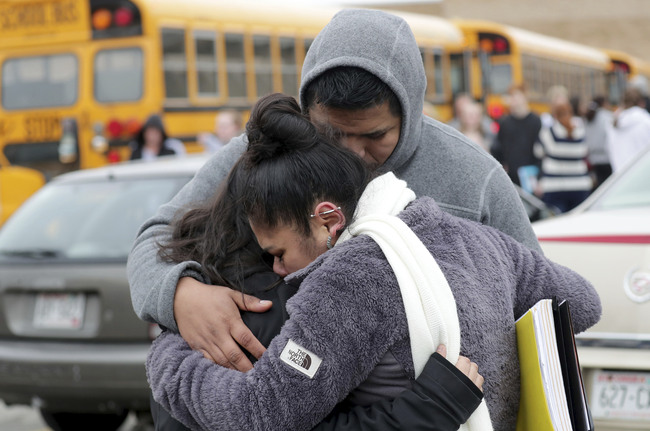 Becky Galvan, center, consoles her daughter, Ashley Galvan, a 15-year-old sophomore, with her father Jose Chavez outside Waukesha South High School in Waukesha on Monday, Dec. 2, 2019. [Photo: AP]