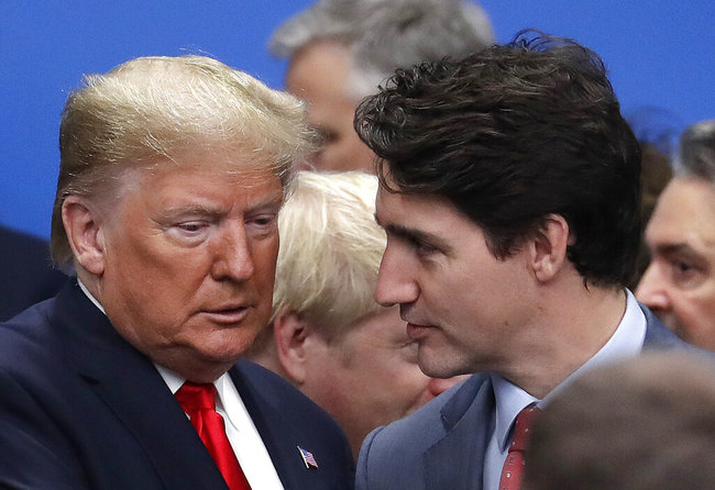 U.S. President Donald Trump, left, and Canadian Prime Minister Justin Trudeau arrive for a round table meeting during a NATO leaders meeting at The Grove hotel and resort in Watford, Hertfordshire, England, Wednesday, Dec. 4, 2019. [Photo: AP]