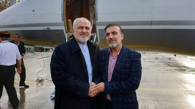 In this photo released on twitter account of Iran's Foreign Minister Mohammad Javad Zarif, left, shakes hand with Iranian scientist Massoud Soleimani prior to leaving Zurich, Switzerland for Tehran, Iran, Dec. 7, 2019. [Photo: Javad Zarif twitter account via AP]