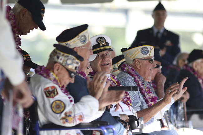 Pearl Harbor survivor Lou Conter, 98, center, who was the only survivor from the USS Arizona to make it to this year's ceremony, smiles during the 78th anniversary of the Japanese attack on Pearl Harbor, Saturday, Dec. 7, 2019 at Pearl Harbor, Hawaii. Survivors and members of the public gathered in Pearl Harbor to remember those killed when Japanese planes bombed the Hawaii naval base 78 years ago and launched the U.S. into World War II. About a dozen survivors of the attack attended the annual ceremony, the youngest of whom are now in their late 90s. [Photo: AP/Caleb Jones]