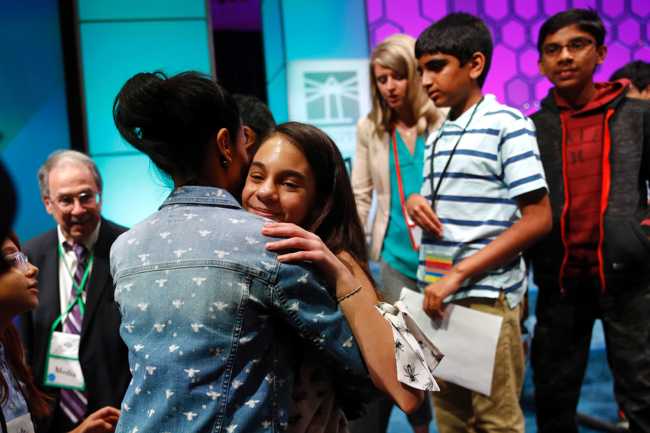 In this Thursday, May 30, 2019, file photo, Simone Kaplan, of Davie, Fla., hugs her mother, Alana, as she walks offstage after reaching the final round of the Scripps National Spelling Bee, in Oxon Hill, Md. [Photo: AP]