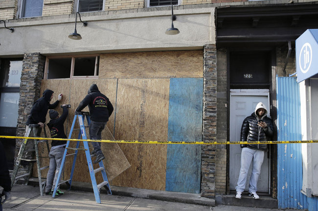 People board up the front of a kosher supermarket thats was the site of a gun battle in Jersey City, N.J., Wednesday, Dec. 11, 2019. The two gunmen in a furious firefight that left multiple people dead in Jersey City clearly targeted the Jewish market, the mayor said Wednesday, amid growing suspicions the bloodshed was an anti-Semitic attack. [Photo: AP]