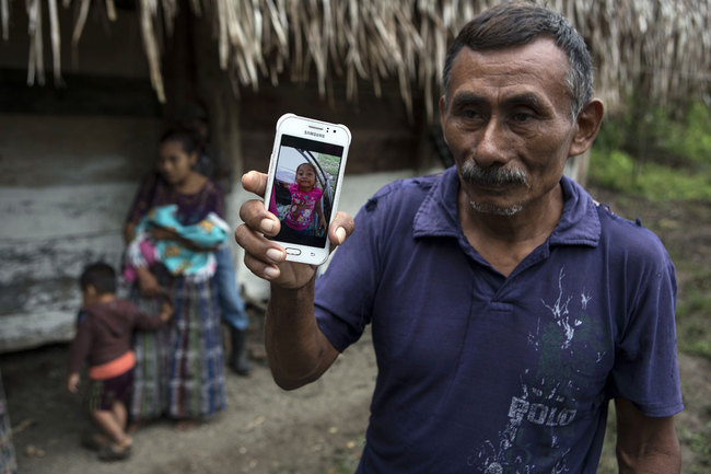 In this photo from December 15, 2018, Domingo Caal Chub, 61, holds a smartphone showing a photo of his granddaughter, Jakelin Amei Rosmery Caal Maquin, in Raxruha, Guatemala. [Photo: AP]