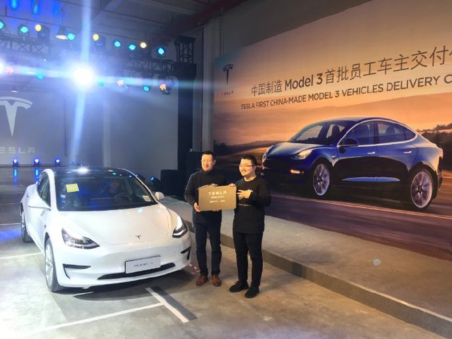 A Tesla employee takes delivery of his China-built Tesla Model 3 at a ceremony at the Tesla Shanghai Gigafactory on December 30, 2019. [Screenshot taken from livestream on Tesla's official Sina Weibo account]