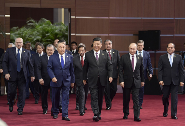 Dne 26. dubna 2019 se prezident Xi Jinping zúčastnil slavnostního zahájení druhého summitu fóra o mezinárodní spolupráci v rámci Pásma a stezky v Pekingu a přednesl hlavní projev s tématem Společně nastolit lepší budoucnost v rámci Pásma a stezky. Na snímku prezident Xi Jinping vstupuje do konferenčního sálu spolu se zahraničními představiteli.