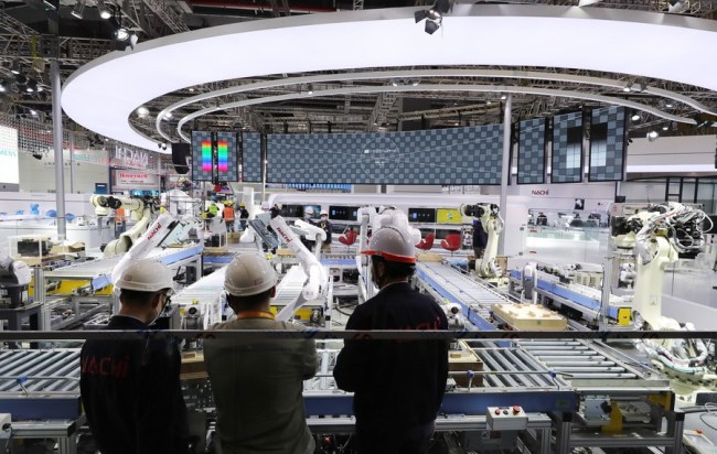 Zaměstnanci ladí stroj na výstavě technických zařízení na 3. Čínském mezinárodním dovozním veletrhu ve východočínské Šanghaji, 2. listopadu 2020. (Xinhua / Fang Zhe)