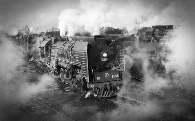 Parní lokomotivy na nádraží Baotou-západ ve Vnitřním Mongolsku v roce 1978. Parní lokomotivy byly provozovány ve velkém množství po celá desetiletí po založení Čínské lidové republiky v roce 1949. Fotografie: Yuan Ruilung (Jüan Žuej-lung) pro deník China Daily