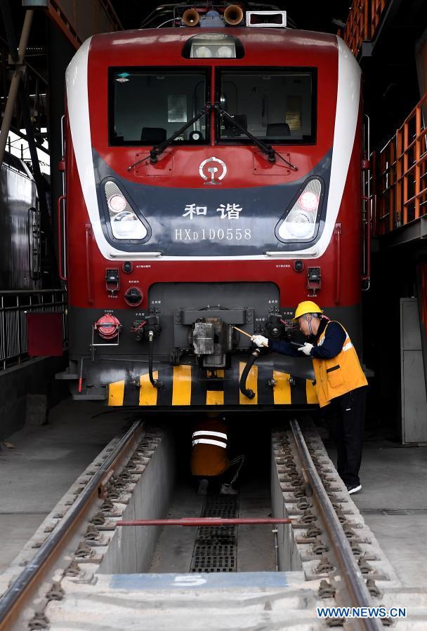 Zaměstnanec společnosti China Railway Zhengzhou Bureau Group Co., Ltd. kontroluje vlak ve městě Zhengzhou (Čeng-čou) v provincii Henan (Che-nan) ve střední Číně, 11. února 2021. Lidé z různých odvětví zastávají své funkce v předvečer čínského lunárního Nového roku, neboli Jarního svátku, který připadá na 12. února. (Xinhua / Li An)