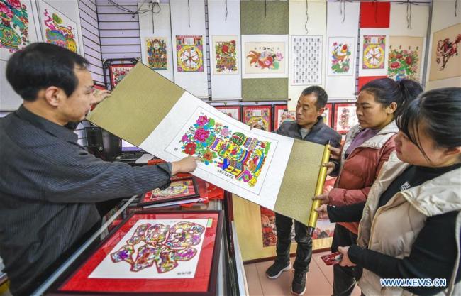 Des clients achètent des estampes de Nouvel An dans un magasin à Wuqiang, district de la province chinoise du Hebei (nord), le 12 janvier 2020. A l'approche de la fête du Printemps, la vente des estampes de Nouvel An est entrée dans sa haute saison à Wuqiang. L'estampe de Nouvel An a été inscrite au patrimoine culturel immatériel national en 2006. (Photo : Li Xiaoguo)