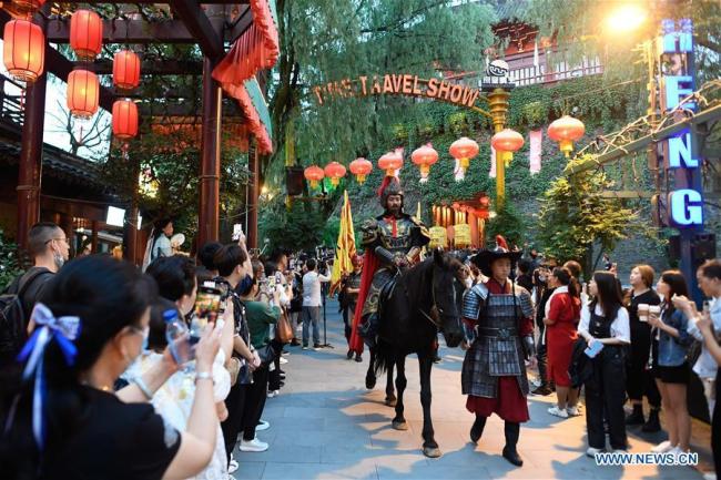 Οι τουρίστες παρακολουθούν παραστάσεις σε γραφικό σημείο που βρίσκεται στο Χαντζόου στην επαρχία Τζετζιάνγκ της ανατολικής Κίνας, στις 26 Σεπτεμβρίου 2020. 
